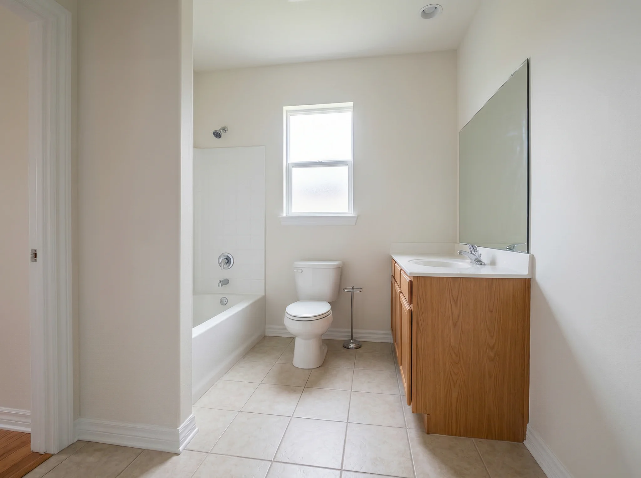 Bathroom with oak vanity before Airbnb accessory styling